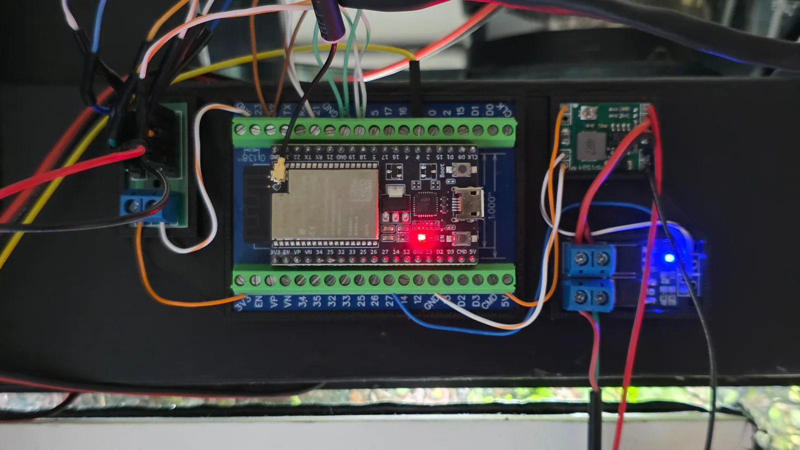 Close-up of a miniBIOTA control board with connected wires and indicator lights.