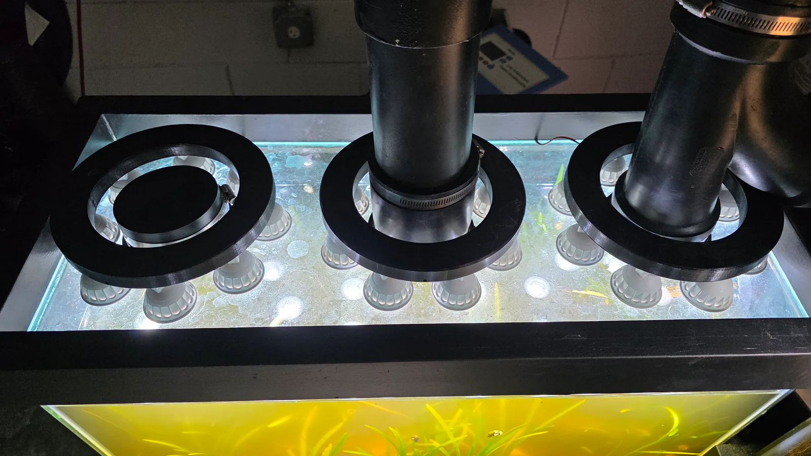 Overhead LED lighting assemblies mounted above the miniBIOTA enclosure.